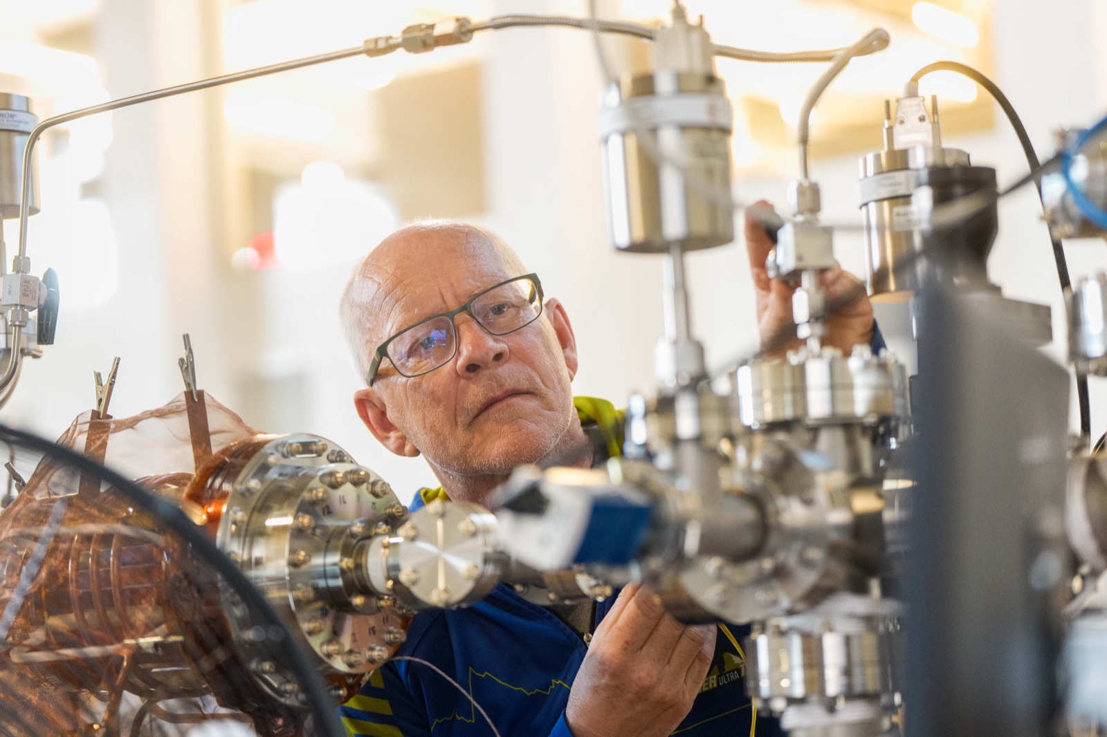 Researcher adjusting copper-mesh laboratory apparatus